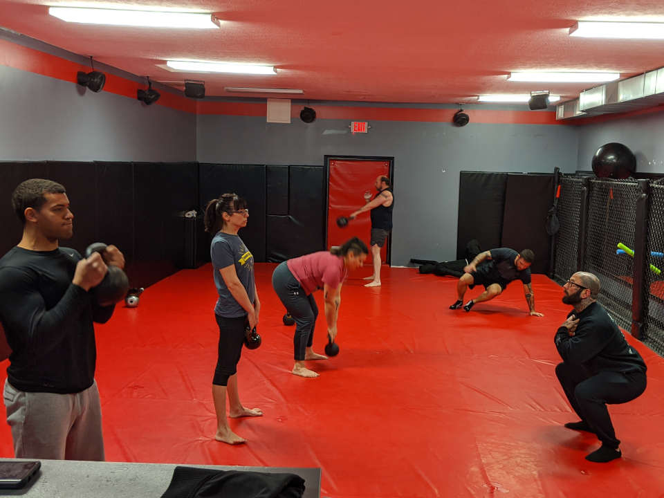 Photo of people working out with kettlebells in the Combat Conditioning class at Indiana Brazilian Jiu-Jitsu Academy