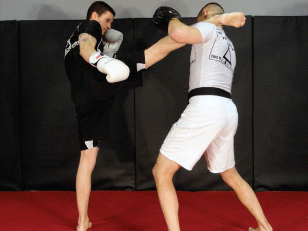 Photo of coach Chris demonstrating a head kick at Indiana Brazilian Jiu-Jitsu Academy