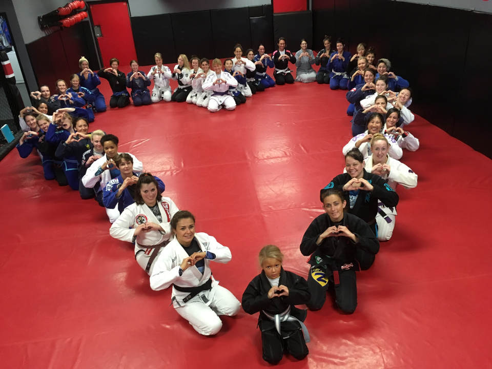 Photo of women arranged in the shape of a heart at Indiana Brazilian Jiu-Jitsu Academy