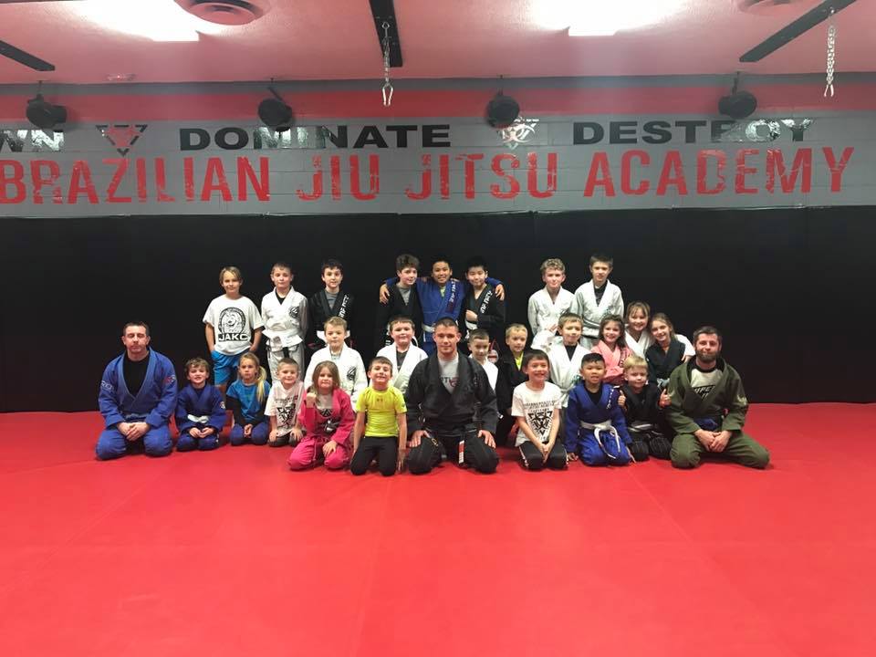 Photo of James Clingerman with the kids of Indiana Brazilian Jiu-Jitsu Academy